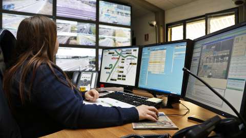 Woman monitors traffic surveillance cameras in milan, italy